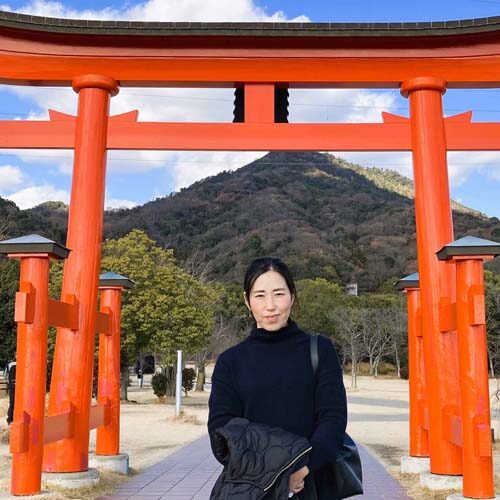 Keiko Sato, JttE Operations Japan member in front of Torii gate
